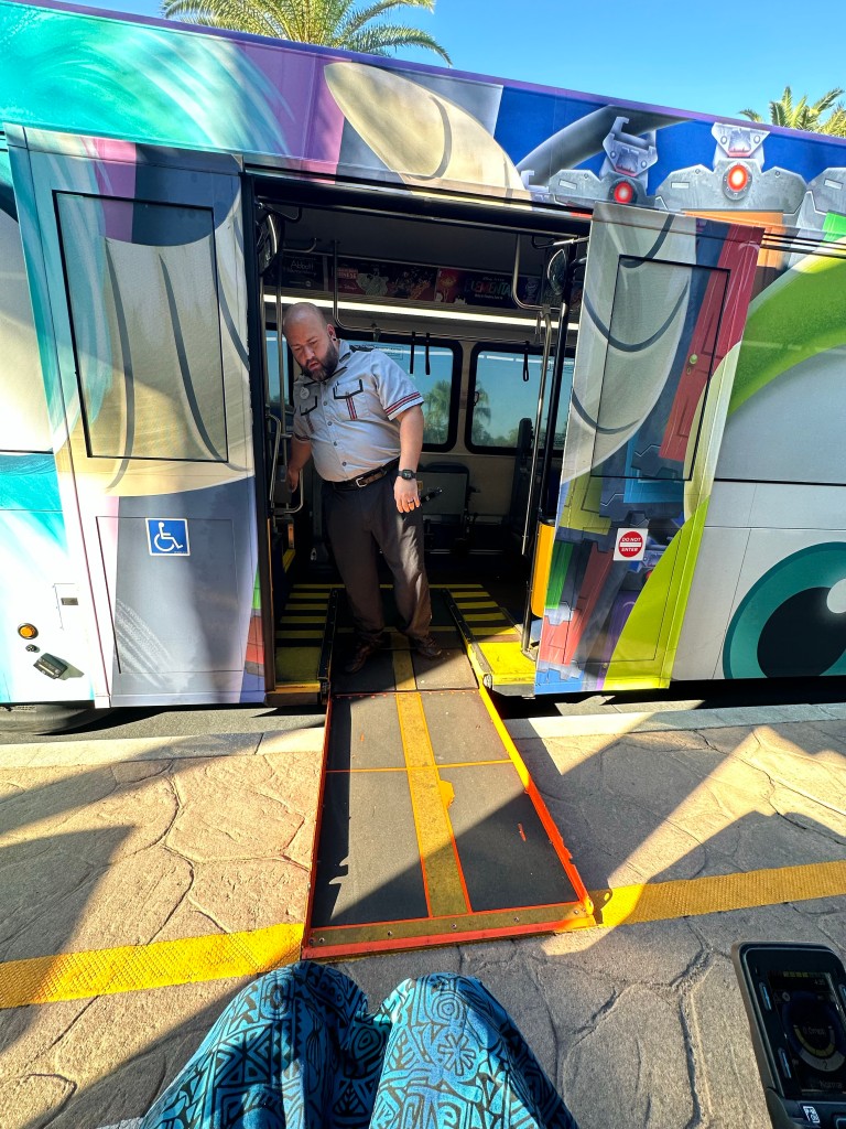 a wheelchair ramp into a colorfully painted bus.